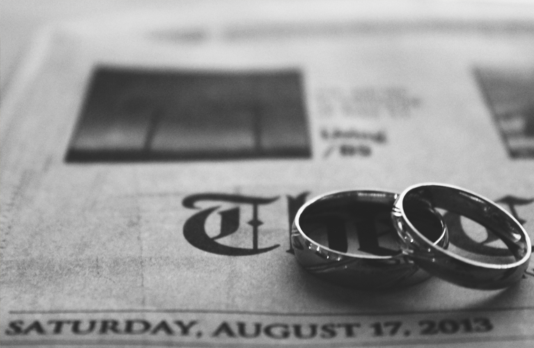 Rings situated on newspaper {Wedding}